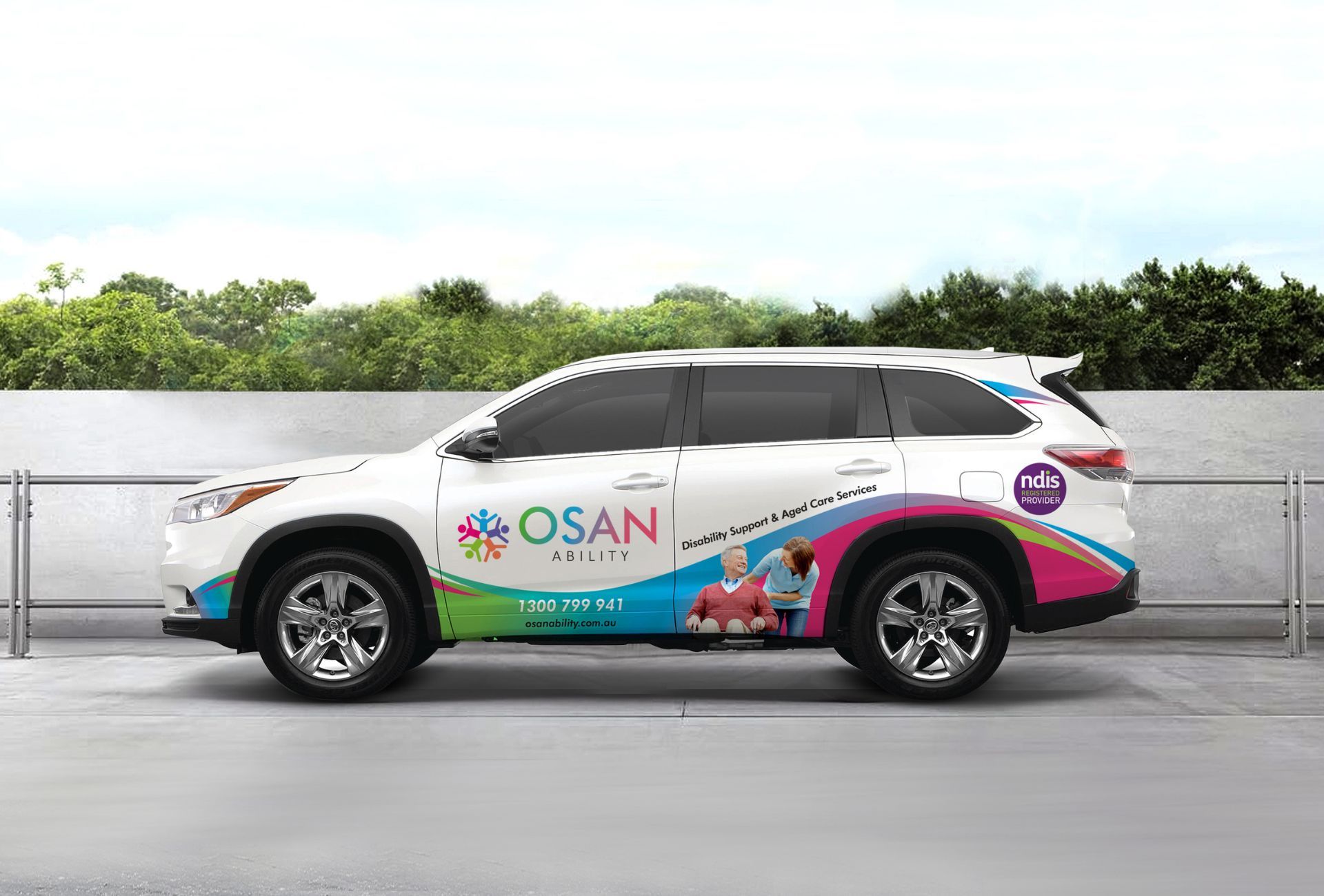 A white suv with a colorful wrap that says osan on it