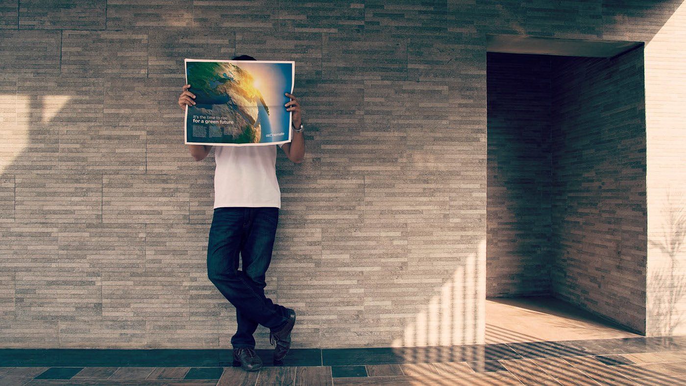A man holding a picture in front of his face