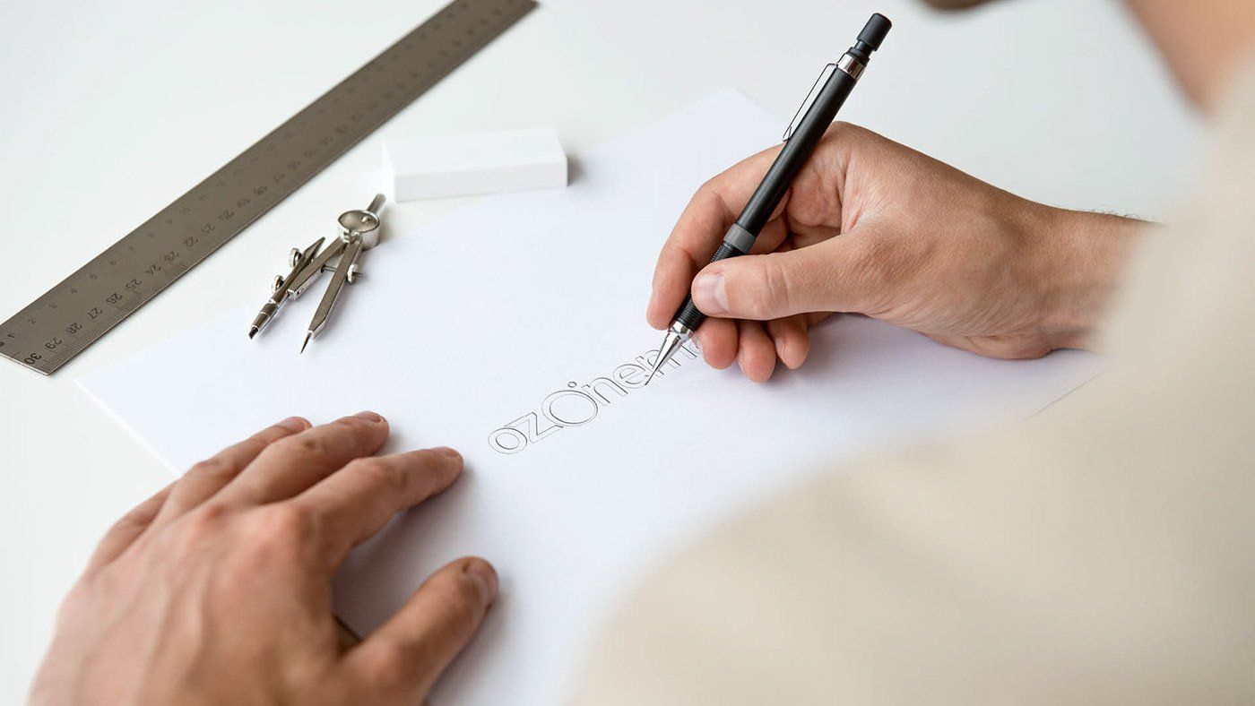 A person is writing on a piece of paper with a pen.