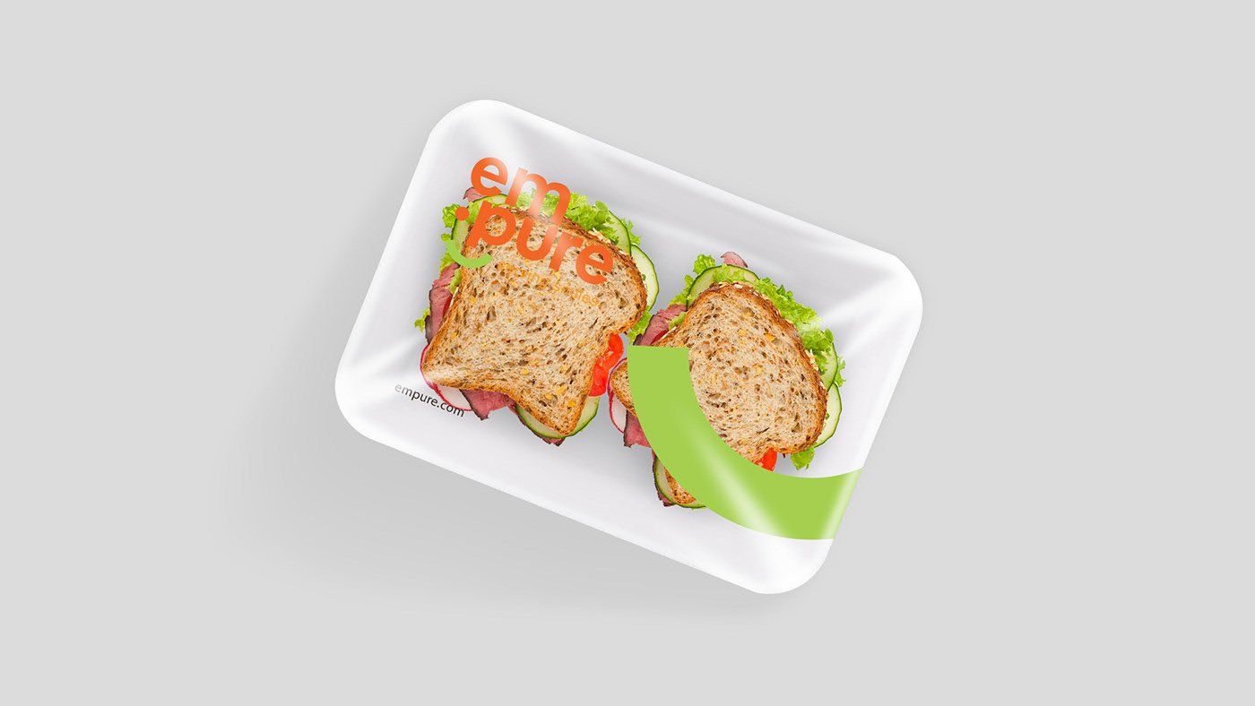 Two sandwiches on a styrofoam tray with a green arrow pointing to the right