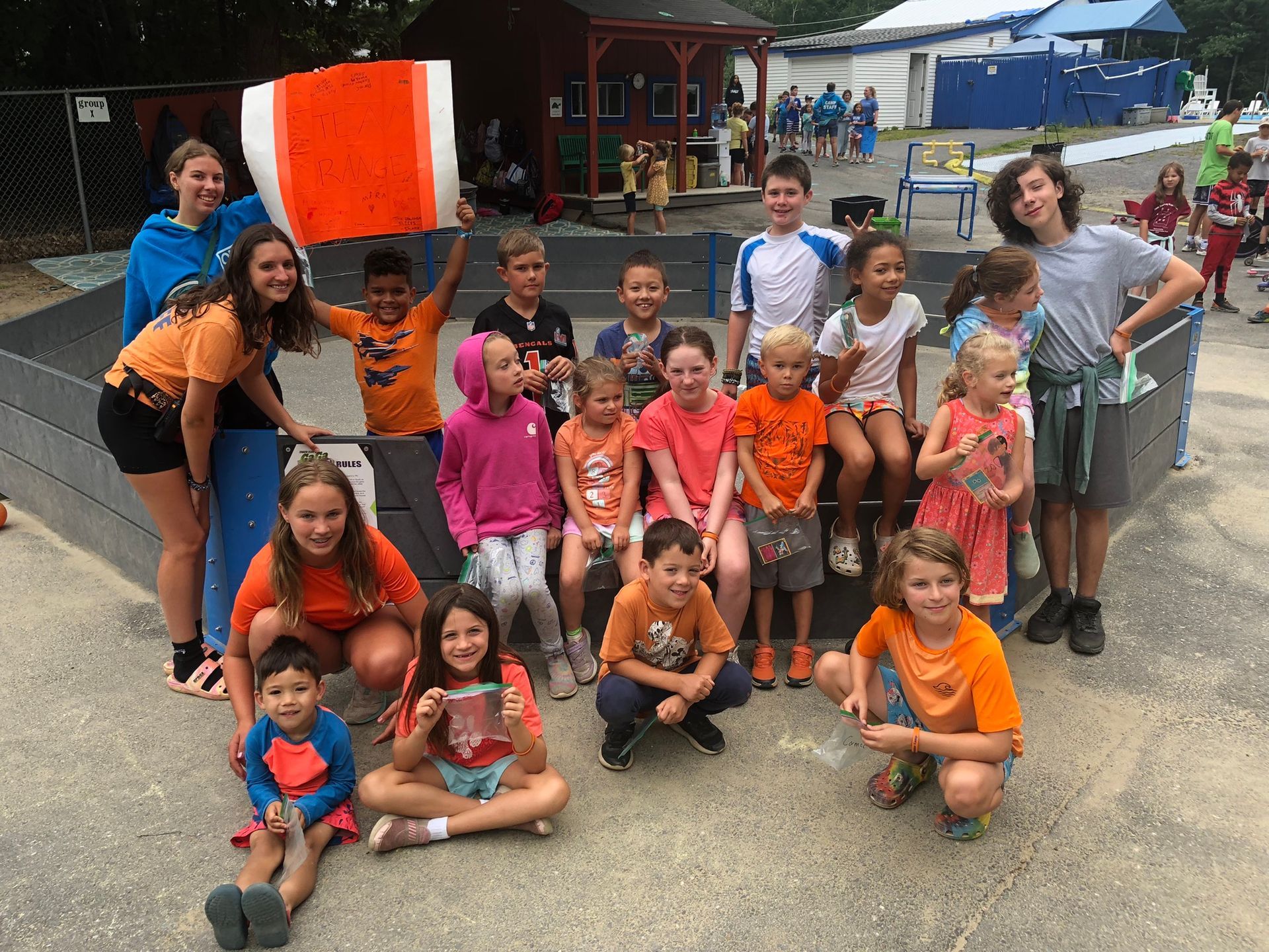 A group of children are posing for a picture in a playground.