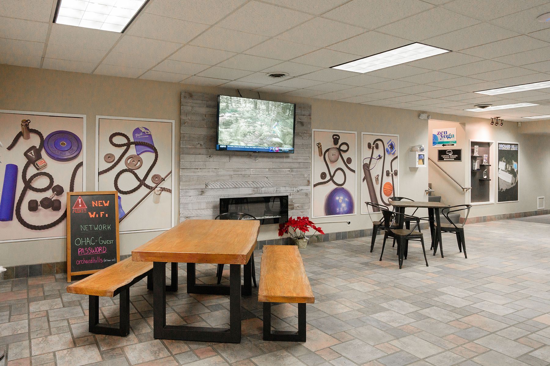 There is a table and benches in the middle of the room.