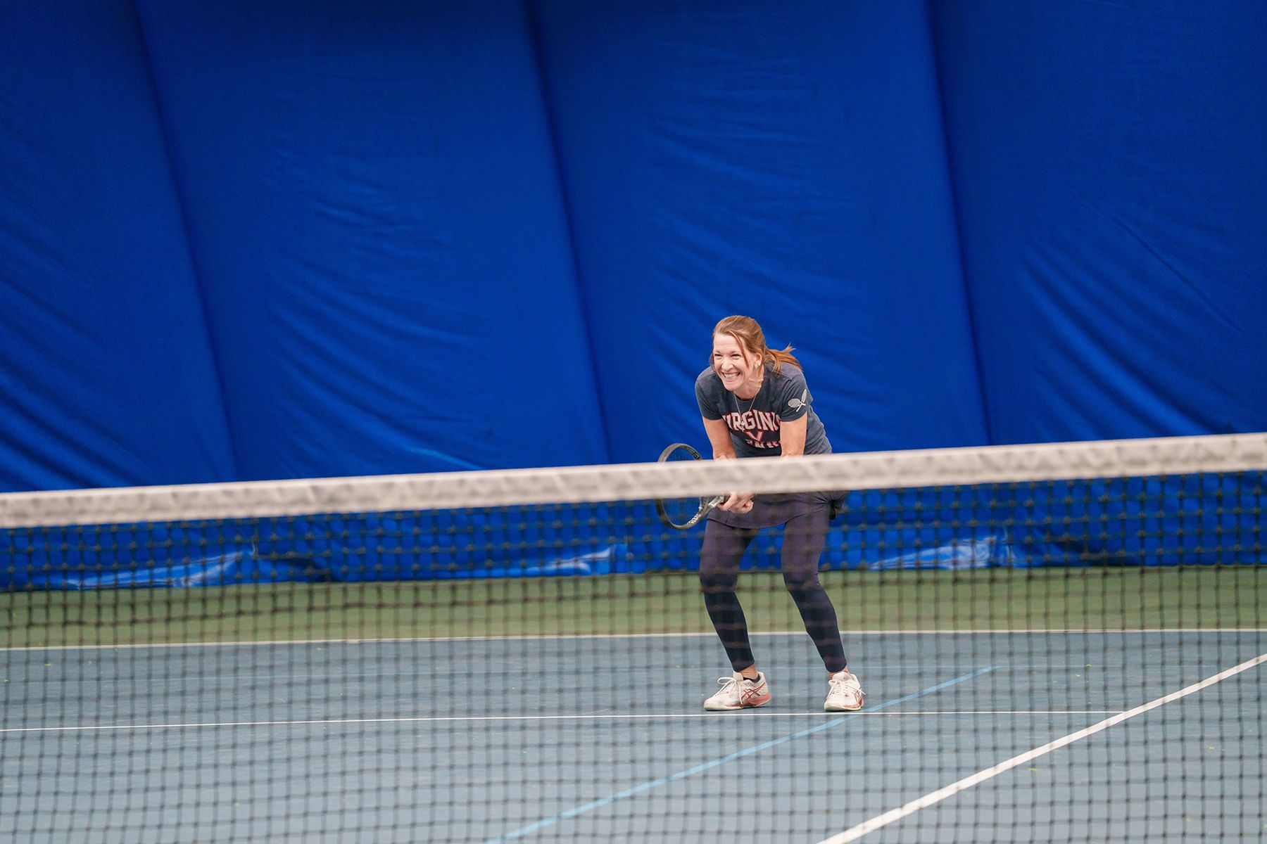 A woman is playing tennis on a tennis court.