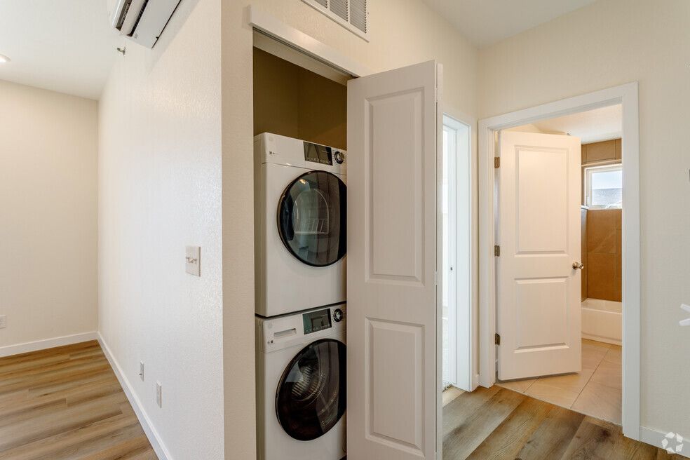 a washer and dryer are stacked on top of each other in a closet .