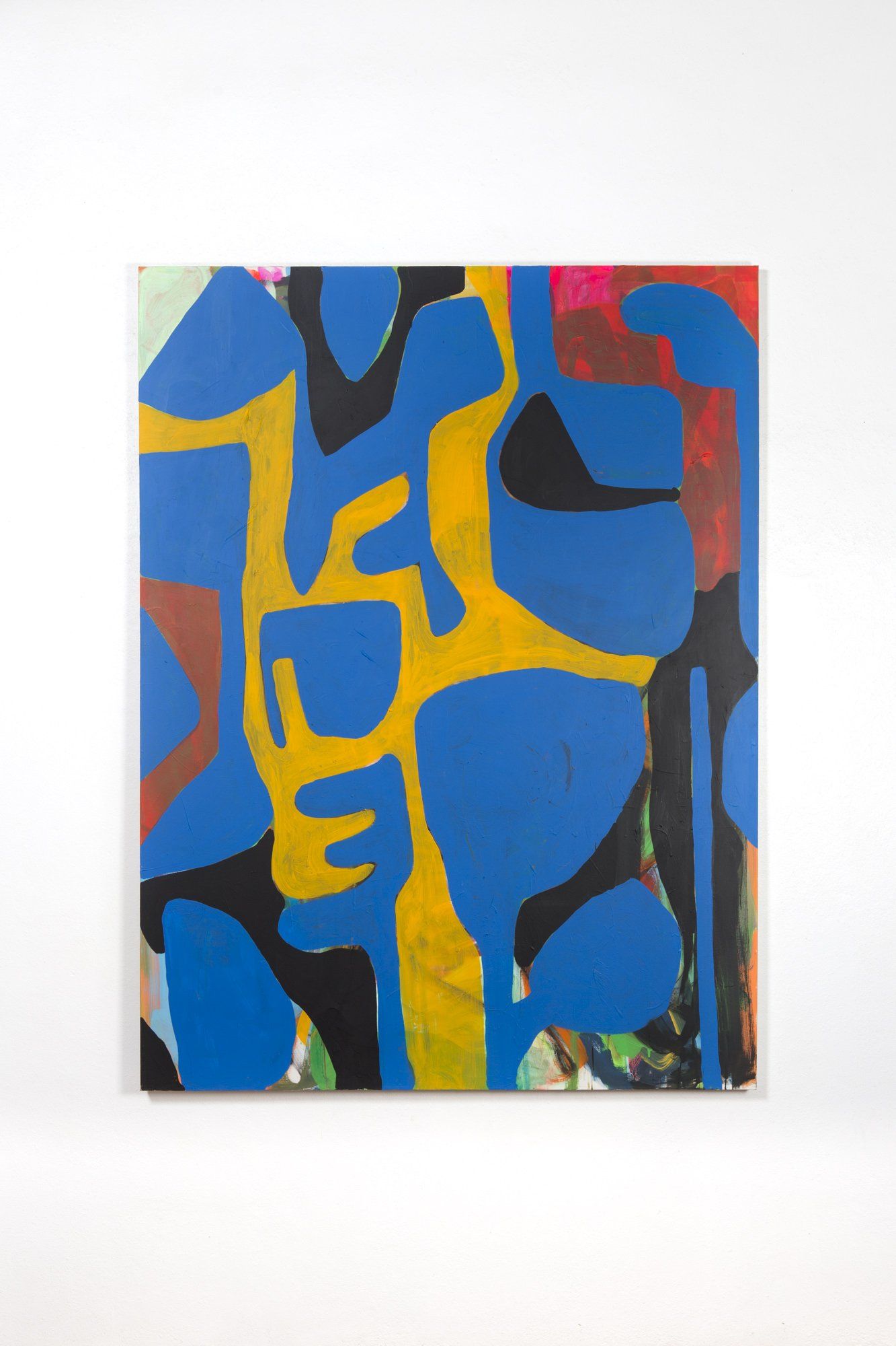 A blue and yellow abstract painting is hanging on a white wall.