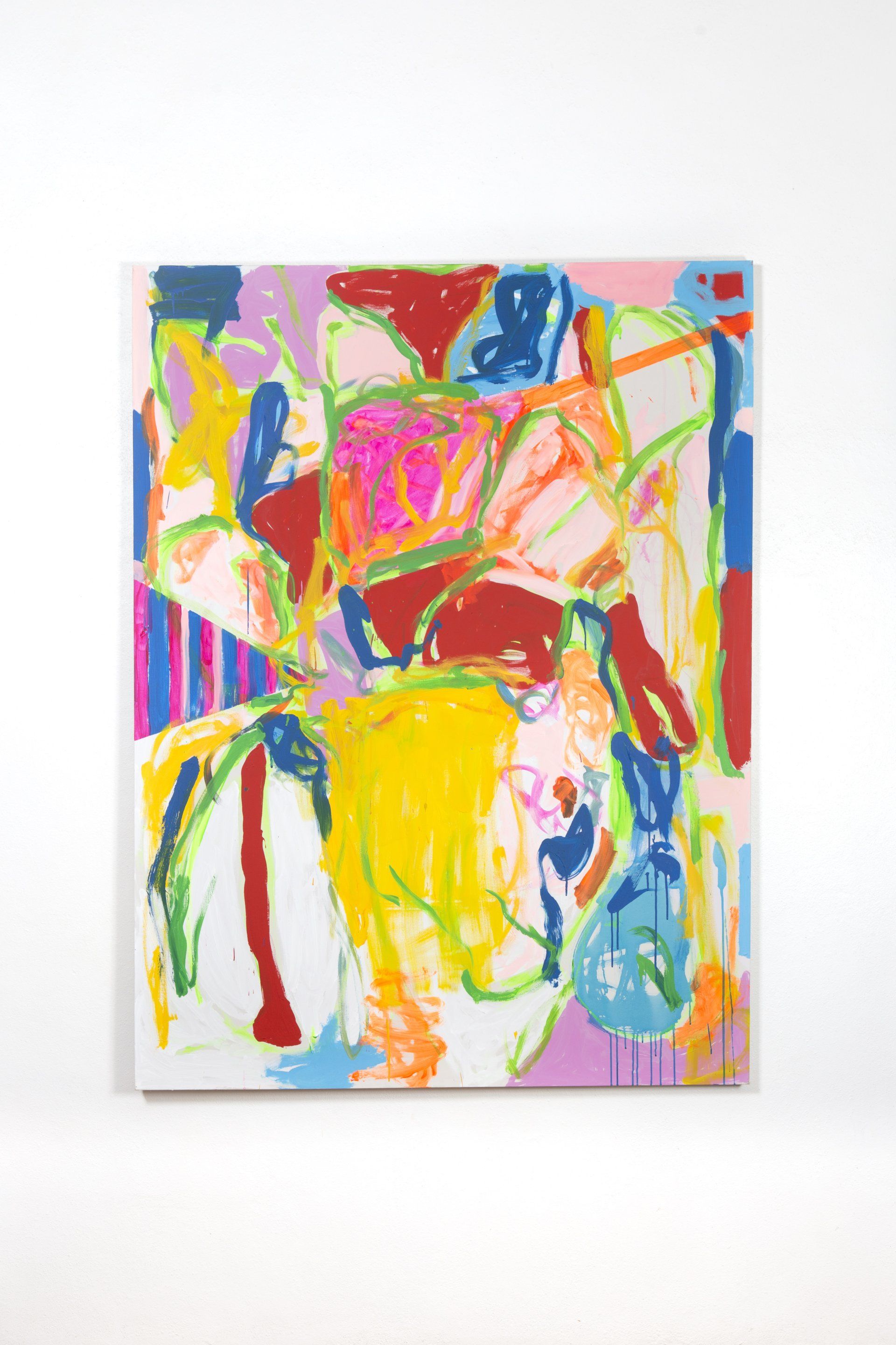 A colorful painting is hanging on a white wall.