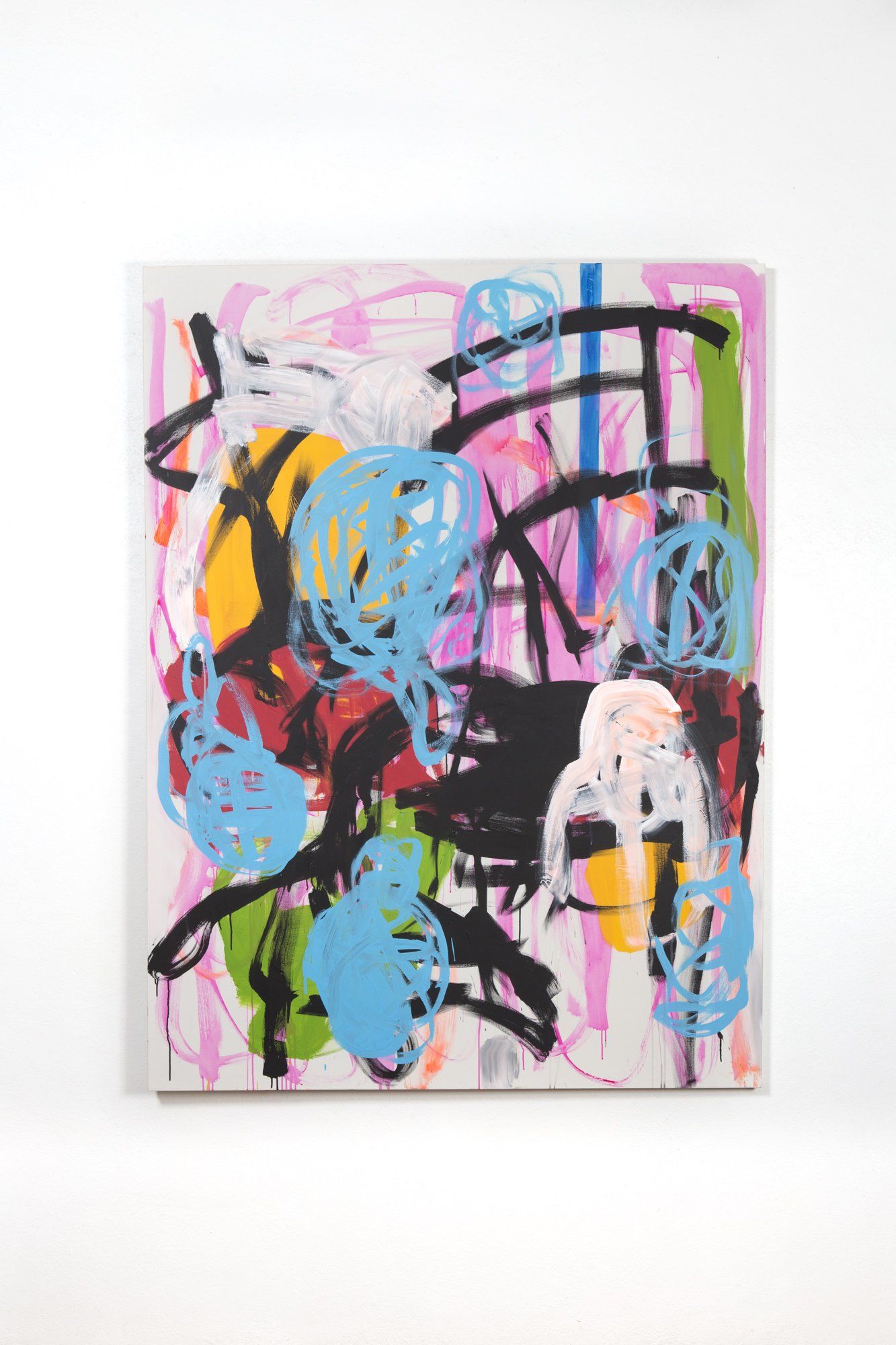 A colorful painting is hanging on a white wall.