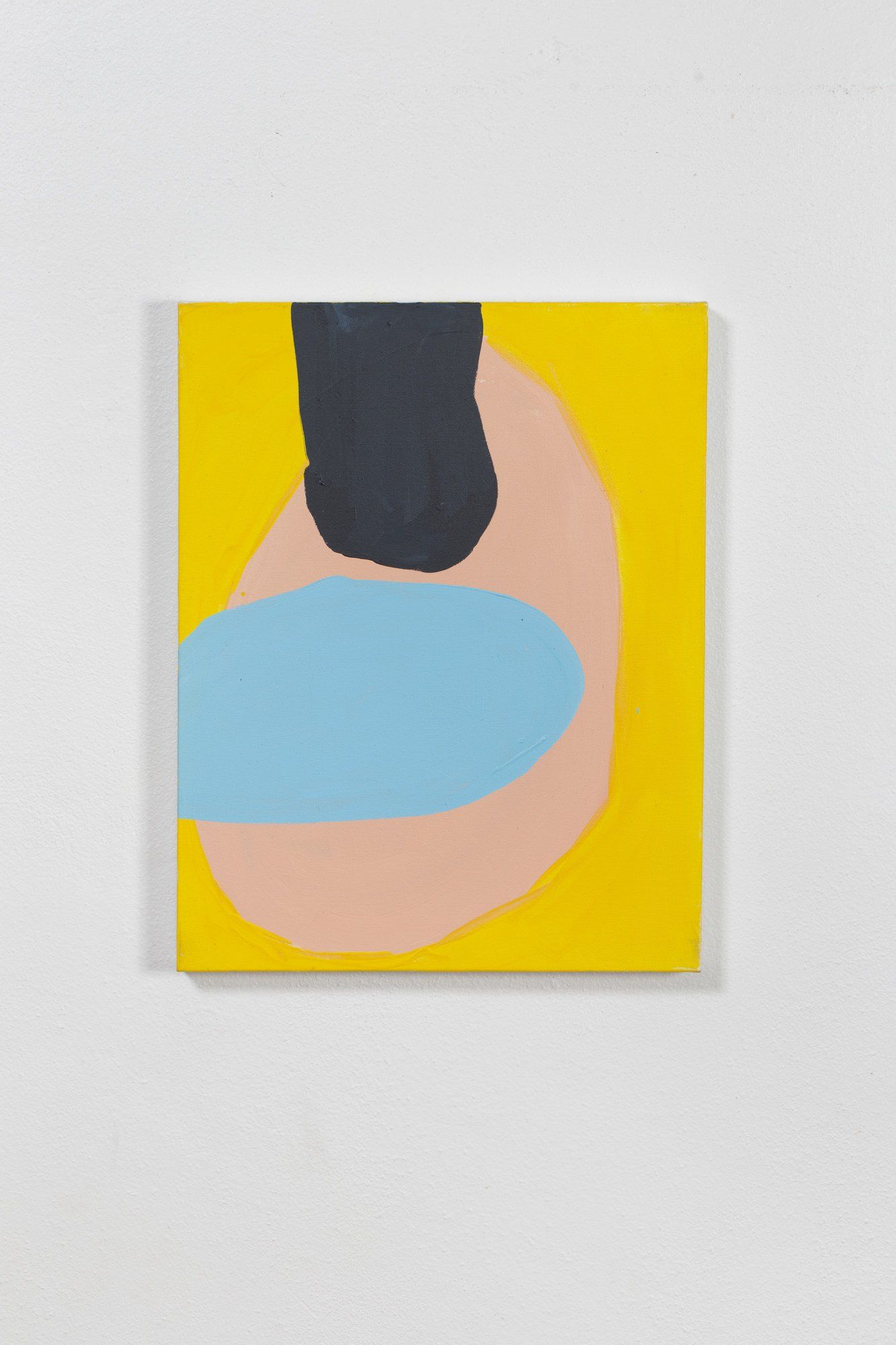 A yellow painting with a pink and blue circle on it