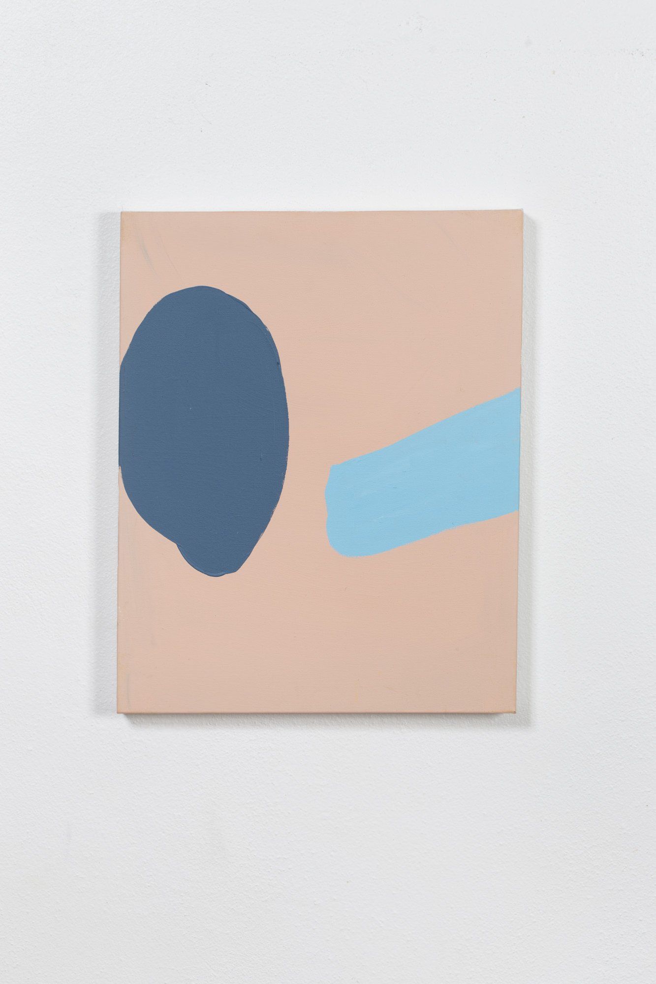 A painting of a blue circle and a blue line on a white wall.