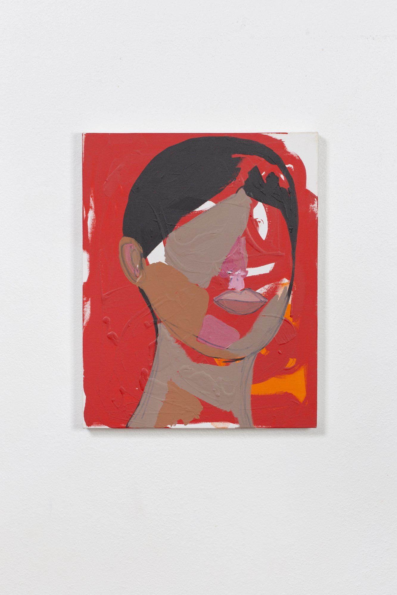 A painting of a woman 's face is on a white wall.