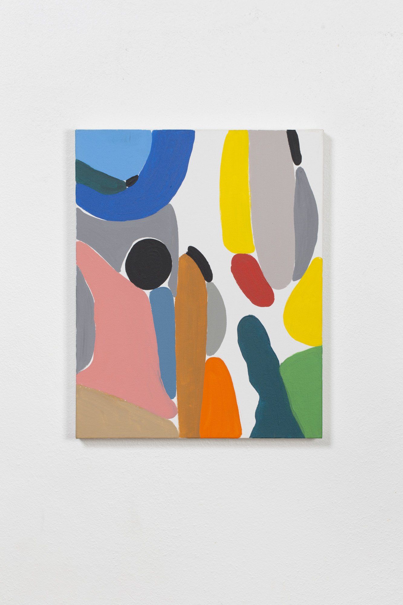 A colorful painting is hanging on a white wall.