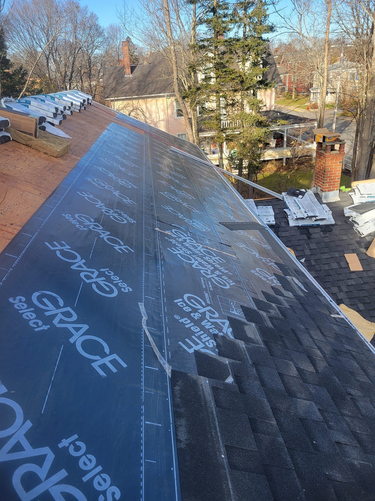 A roof with a lot of shingles being installed on it.