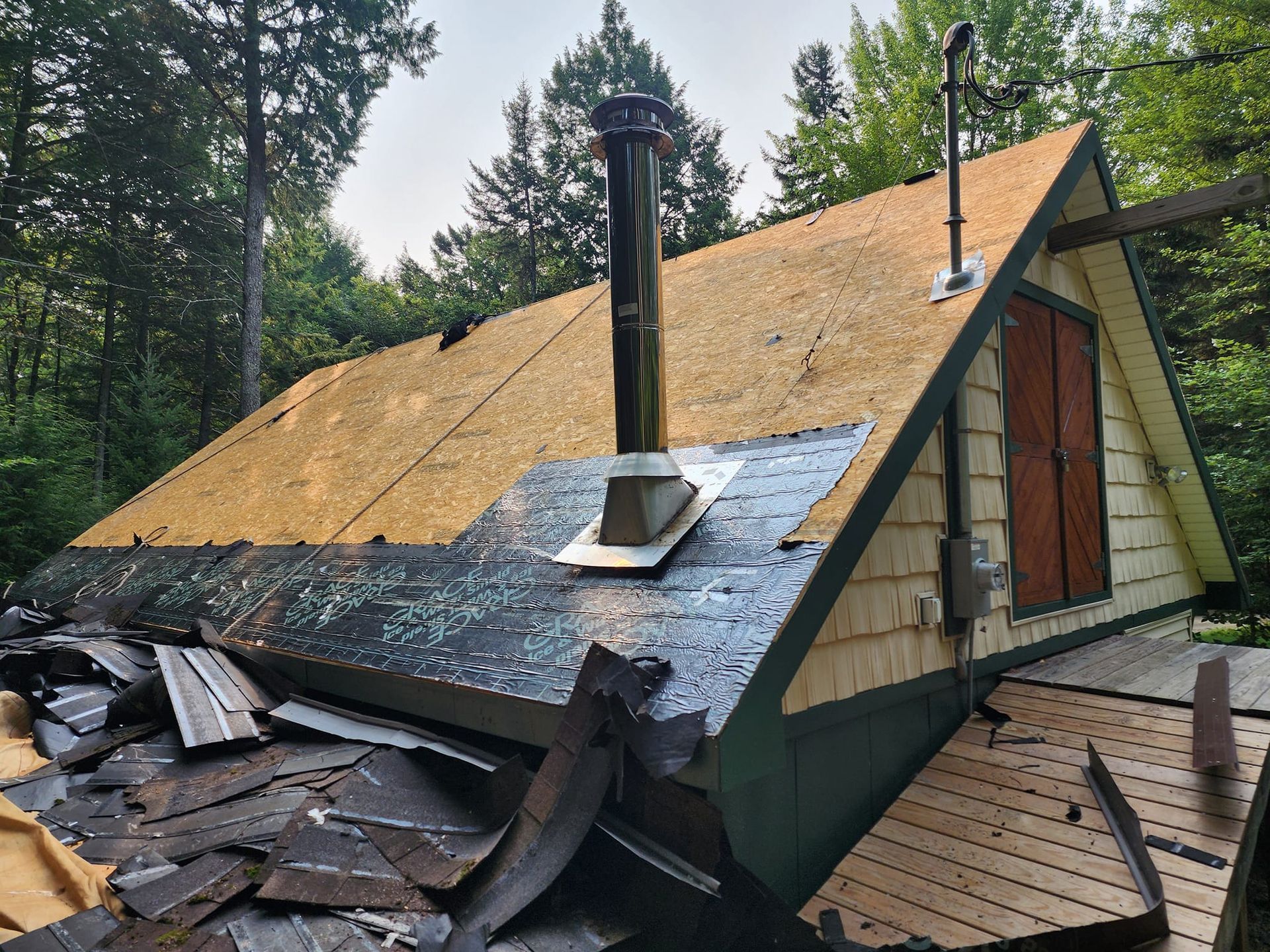 A house with a chimney on the roof is being remodeled