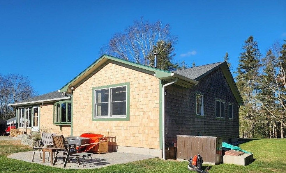 A house with a patio and a hot tub in front of it.