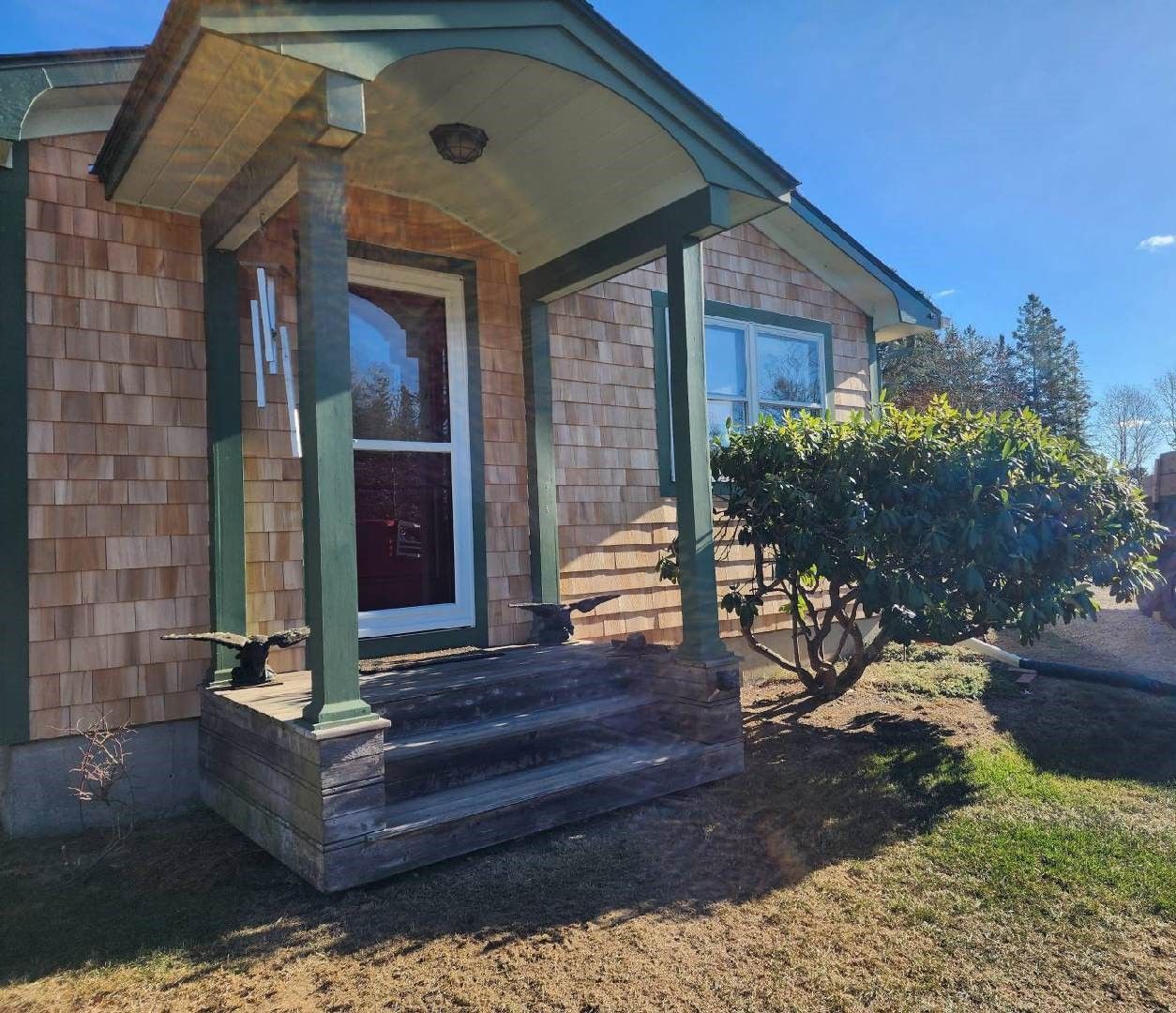A small house with a porch and stairs
