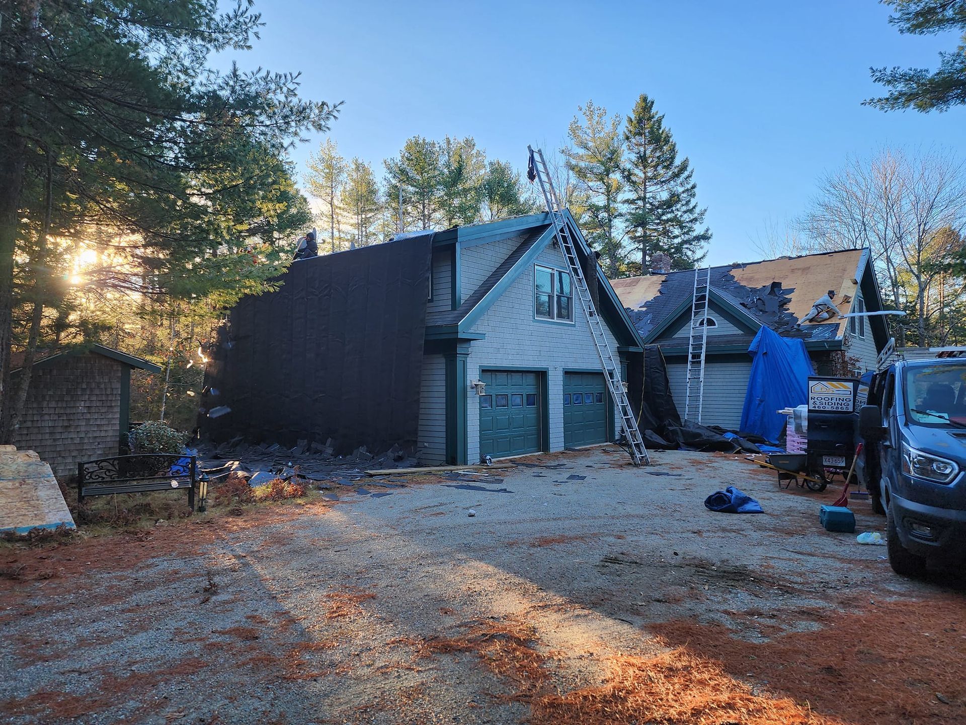 A car is parked in front of a house that is being remodeled.