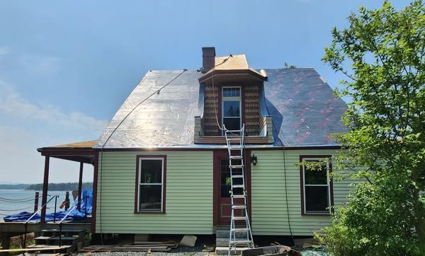 A house with a ladder on the front of it.