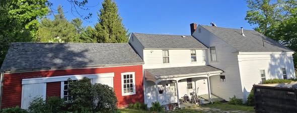 A red and white house with a gray roof
