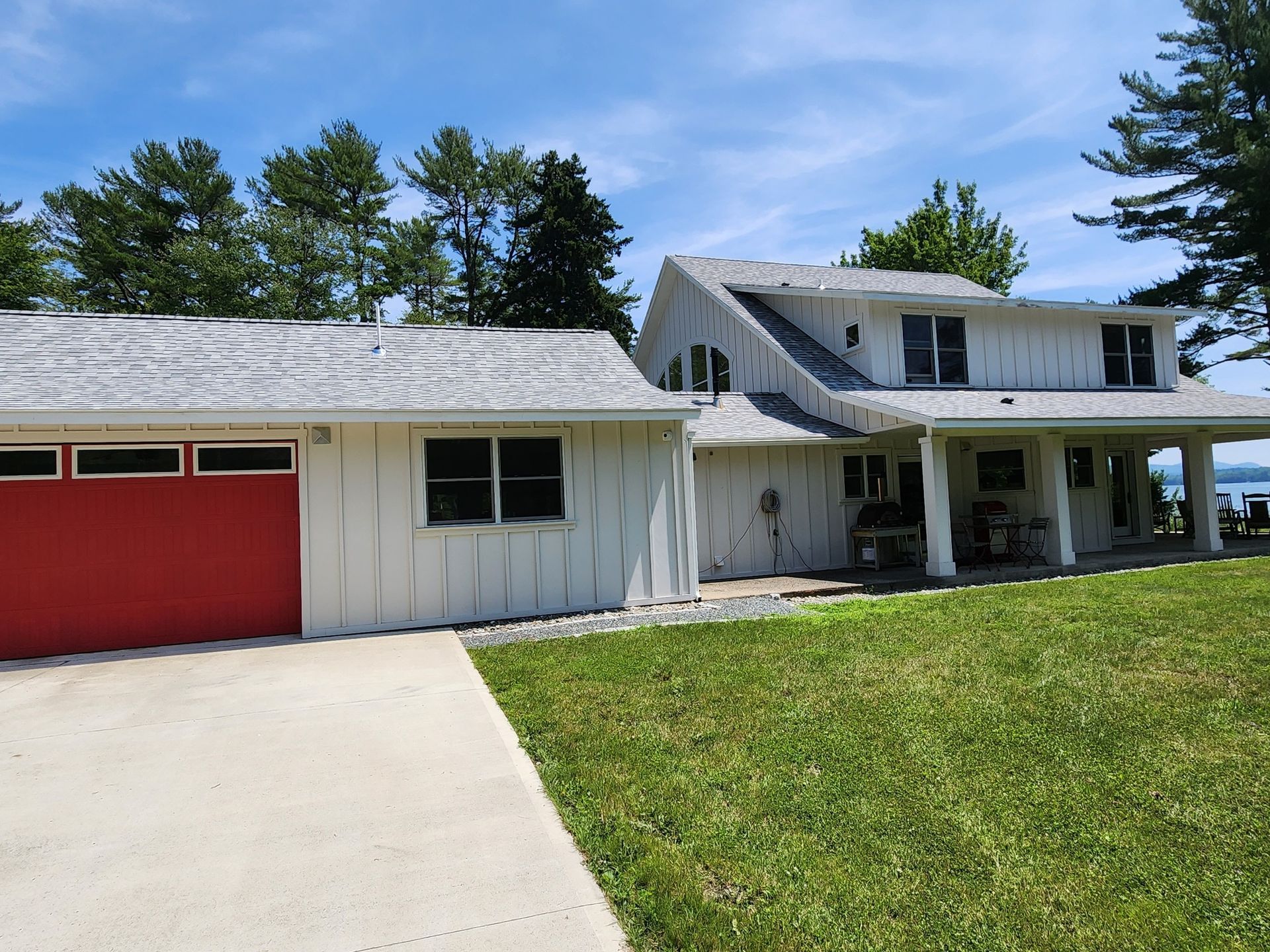 A white house with a red garage door