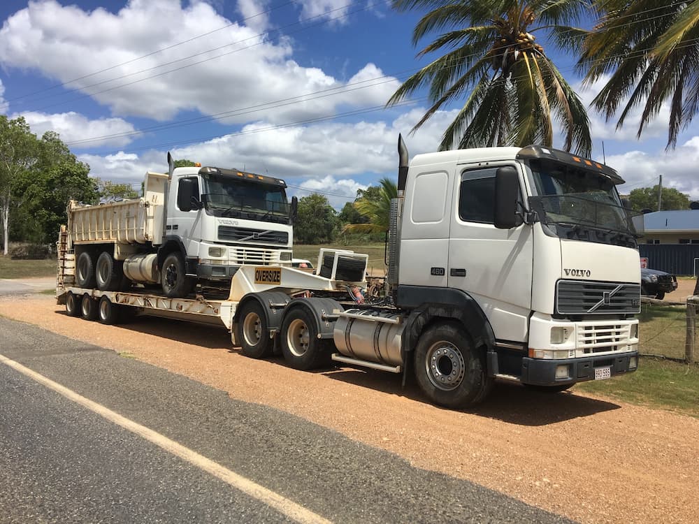 Tipper Truck on the Flatbed Trailer — Riley Earthmoving in Deeragun, QLD