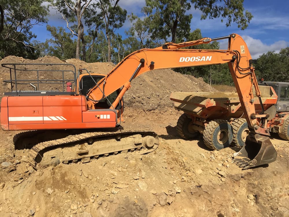 Mini Excavator Transferring Soil in the Tipper Truck — Riley Earthmoving in Deeragun, QLD