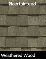 A picture of a weathered wood roof shingle.