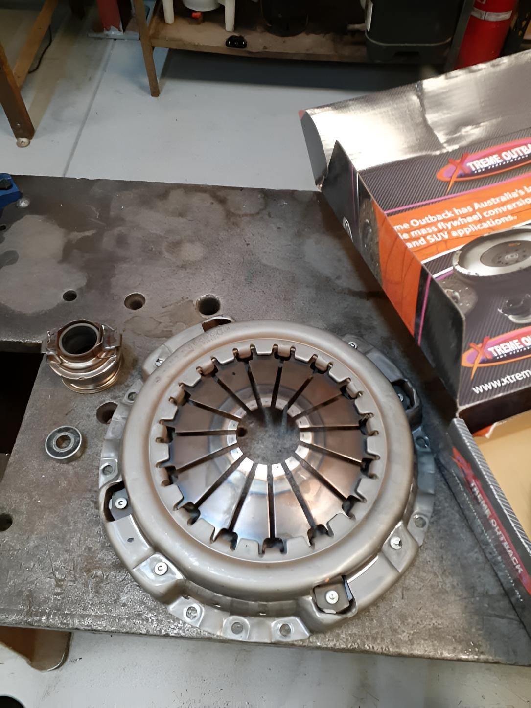 A Clutch Cover Is Sitting On Top Of A Metal Table — Brake & Clutch Automotive Services In Ciccone, NT