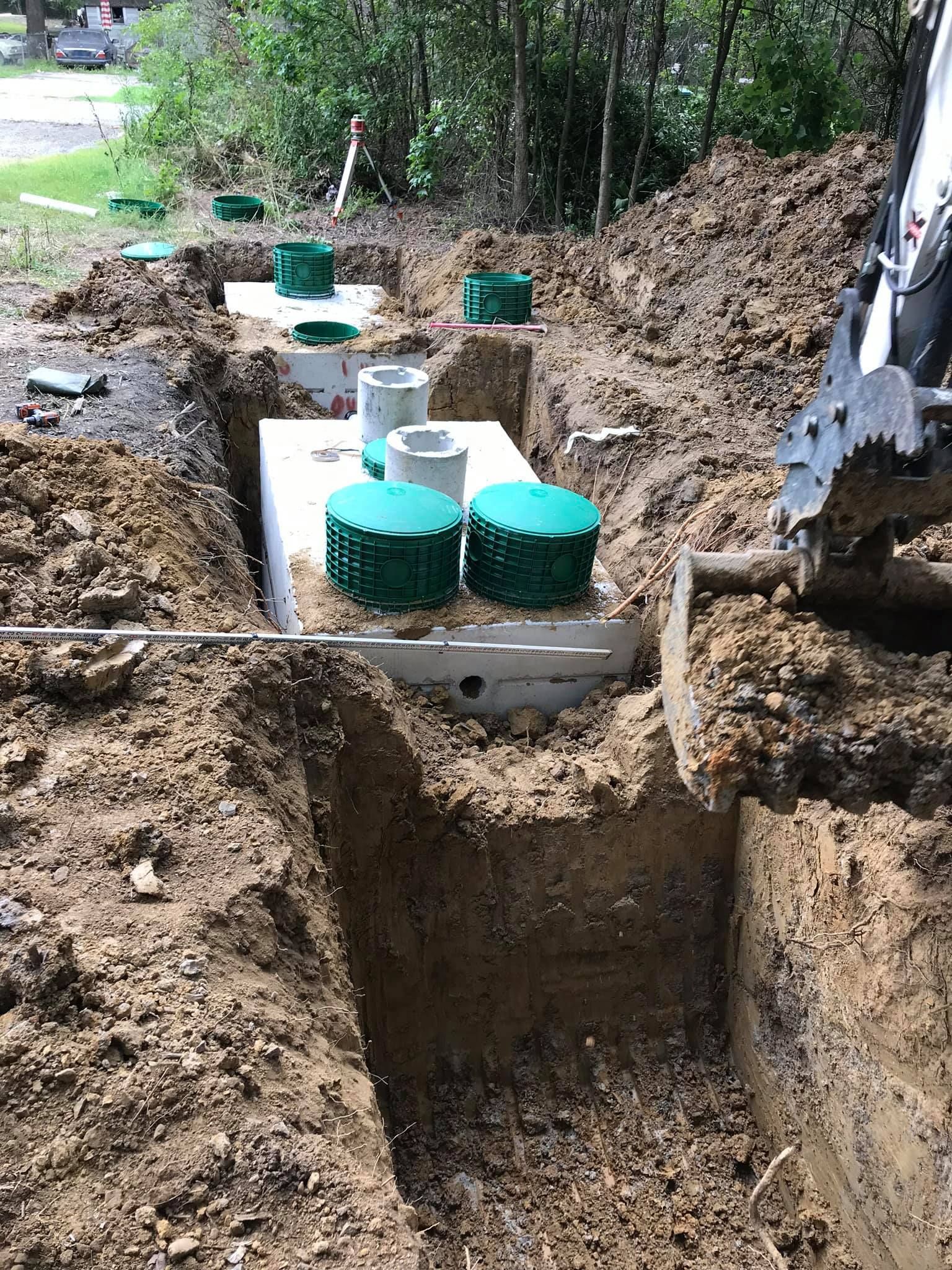 a septic tank is being installed in a hole in the ground .