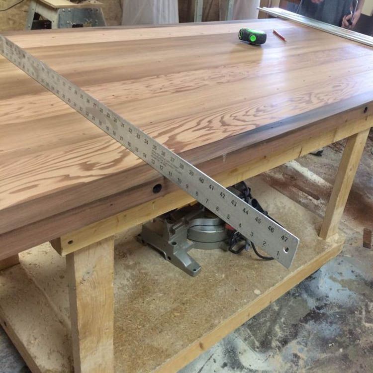 A custom wooden table with a ruler attached to it