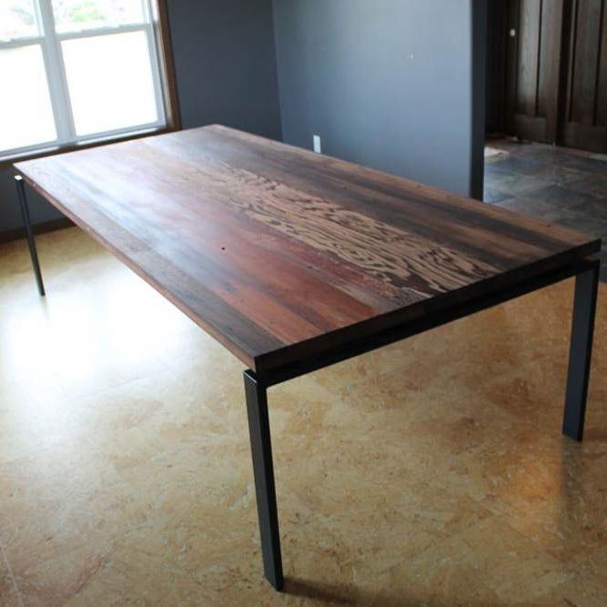 A reclaimed wooden table in a room with a window