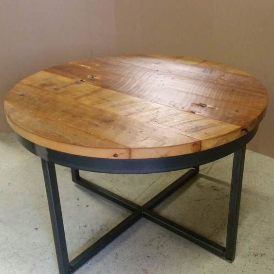 A round custom built wooden table with a metal frame