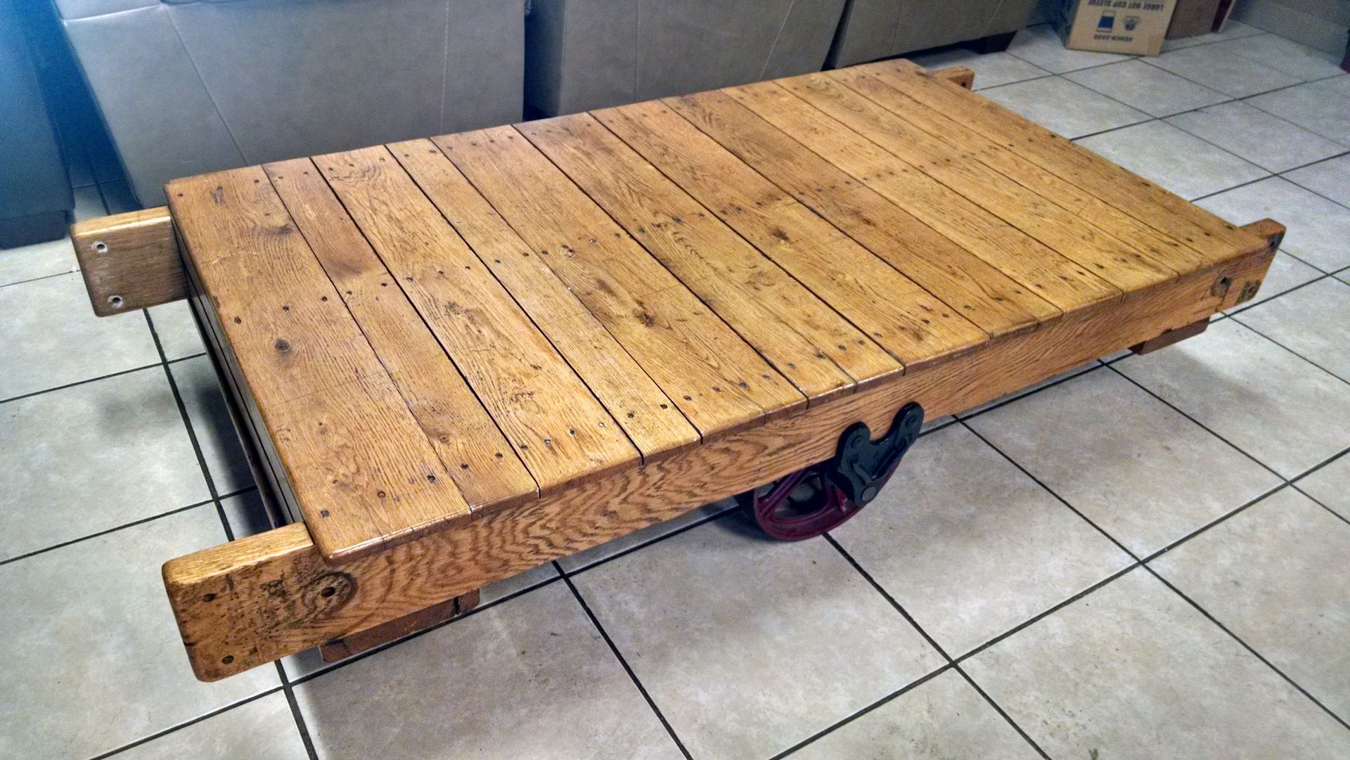 A wooden table is sitting on a tiled floor.