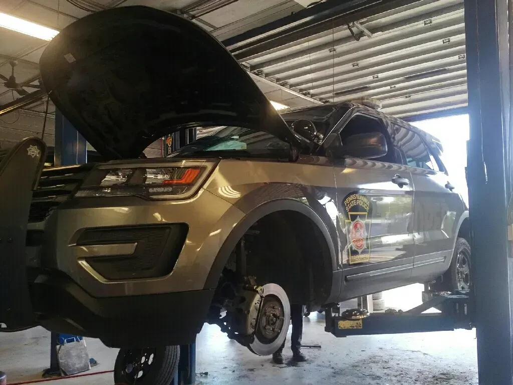 Police SUV on a Lift with Hood Open | Hippensteel Auto Inc.