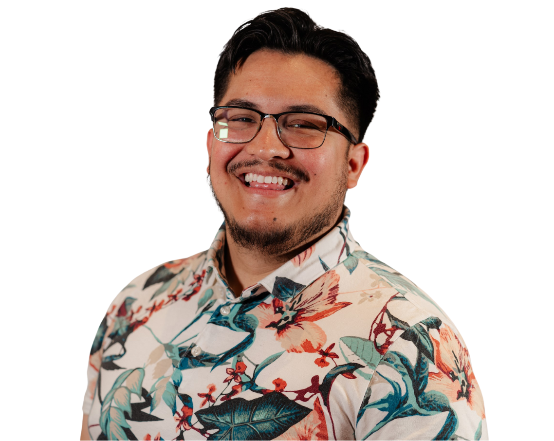A man wearing glasses and a floral shirt is smiling. Christian.