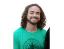 A man with curly hair and a beard wearing a green shirt