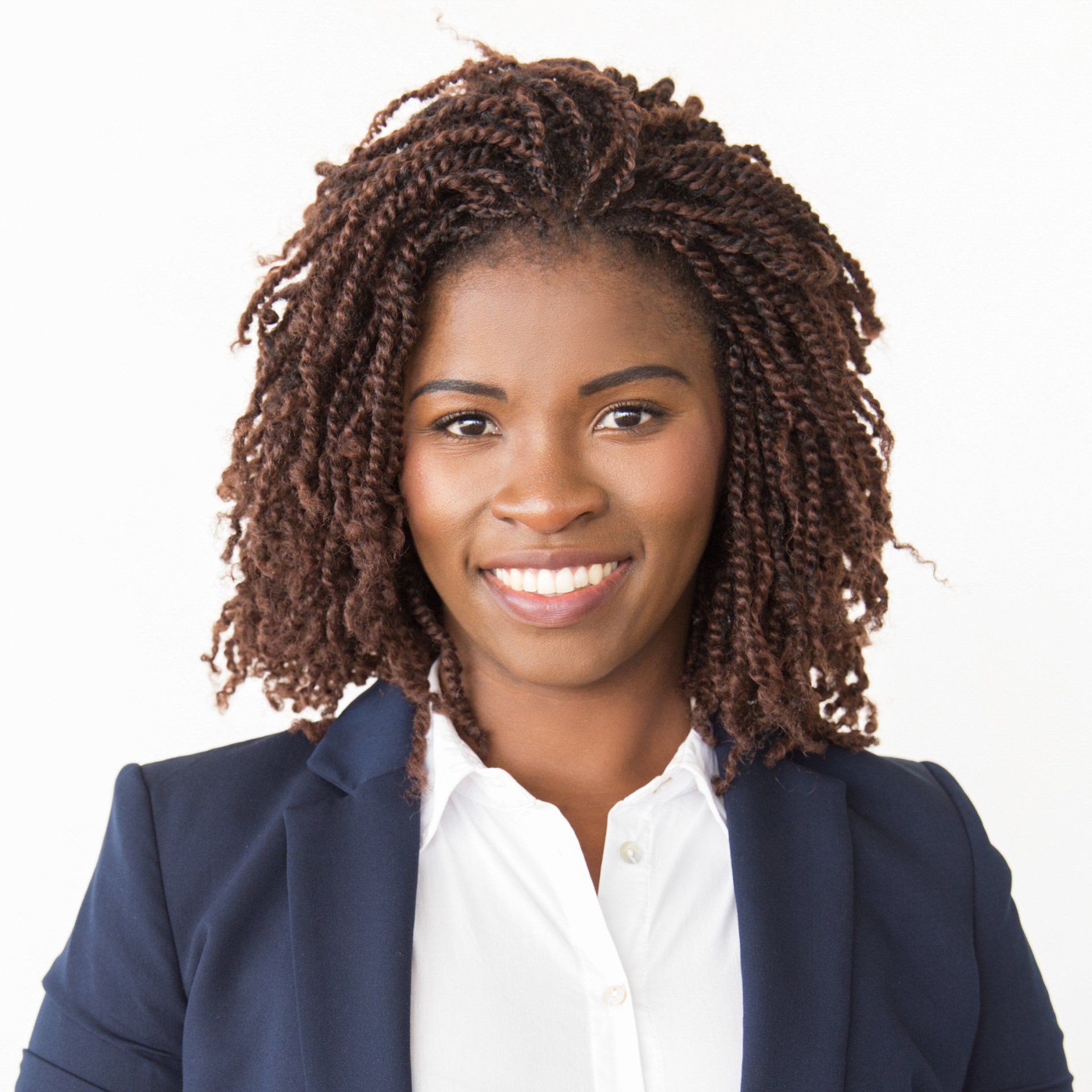 A woman with dreadlocks is smiling and wearing a blue jacket