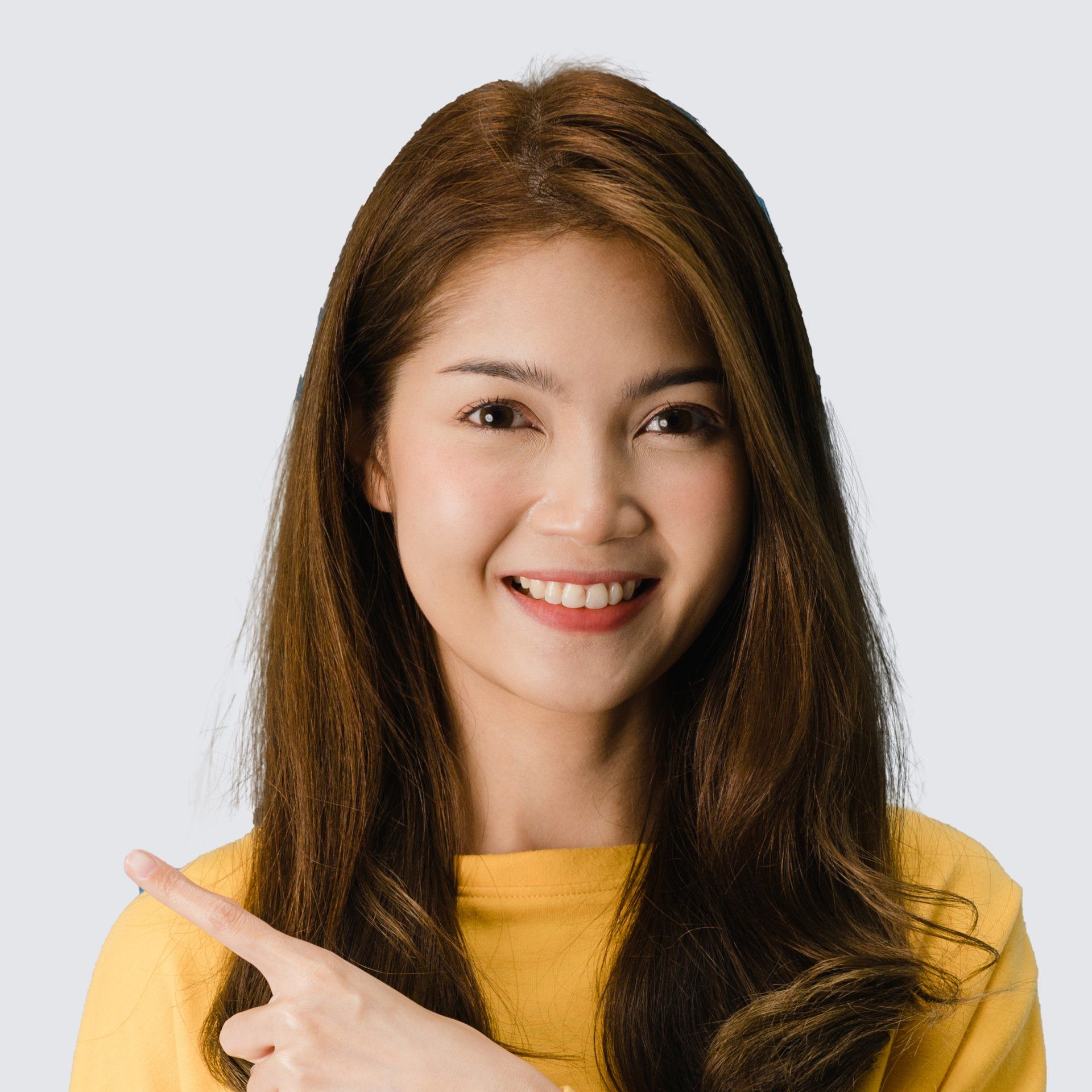 A woman in a yellow shirt is smiling and pointing to the side.
