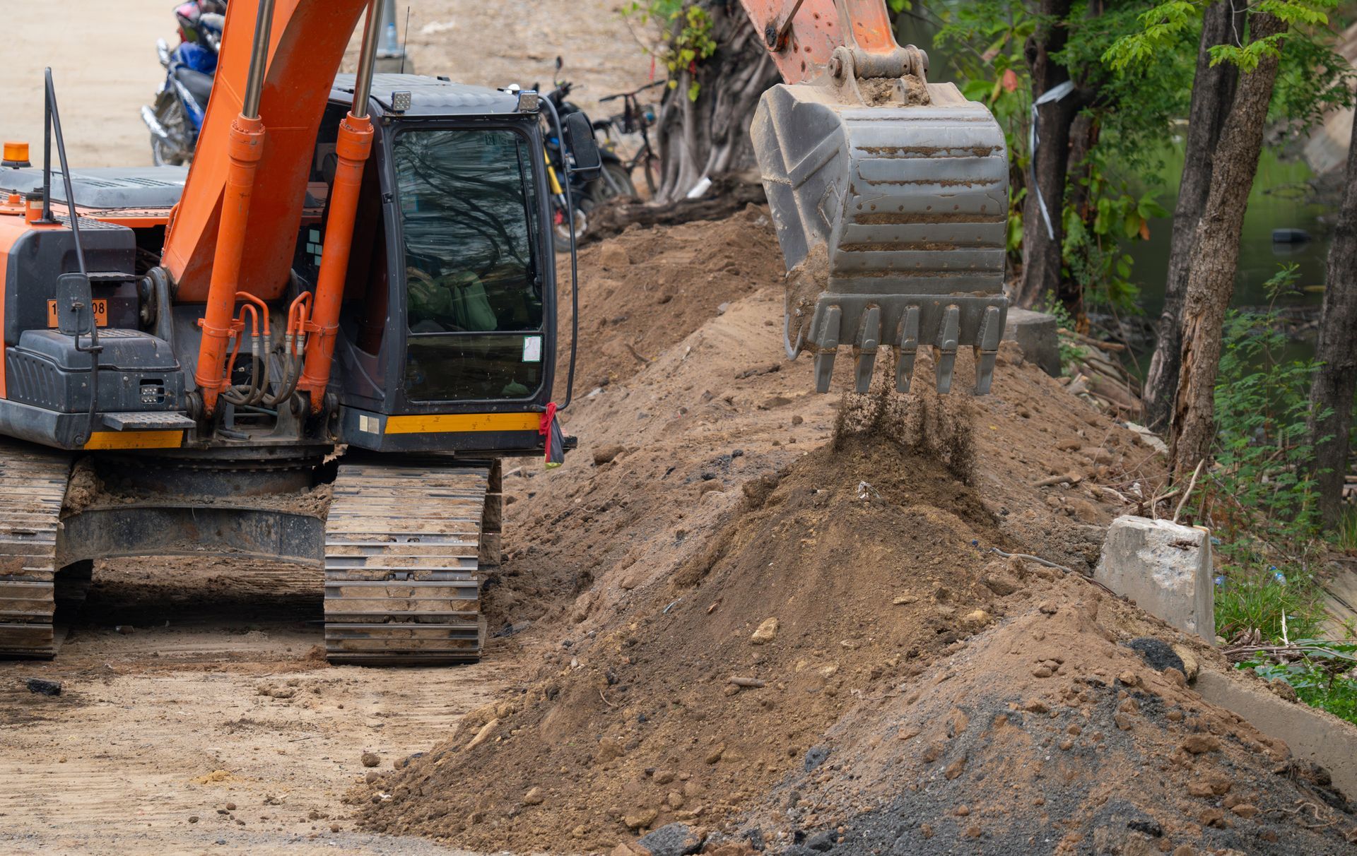 A large excavator is moving dirt on a construction site.