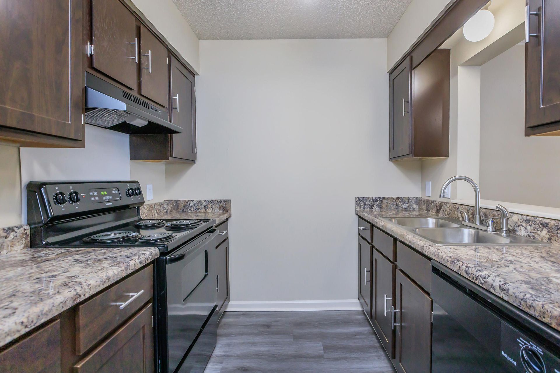 Woodland Oaks kitchen with a stove , sink , and dishwasher.