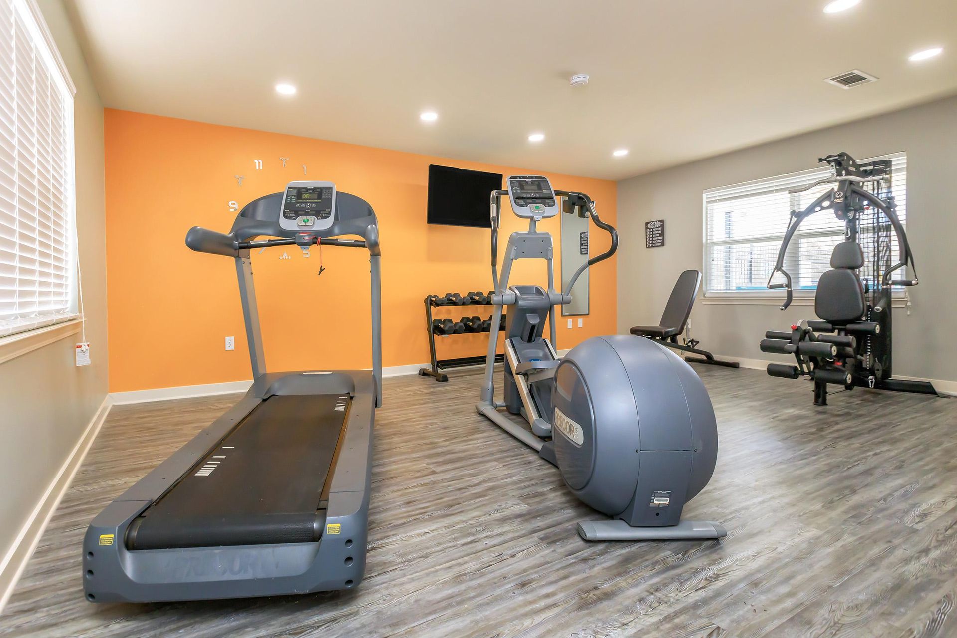 Woodland Oaks gym complete with a  treadmill and an elliptical in the gym.