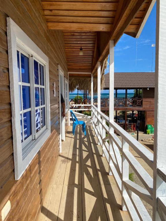 A wooden house with a balcony overlooking the ocean