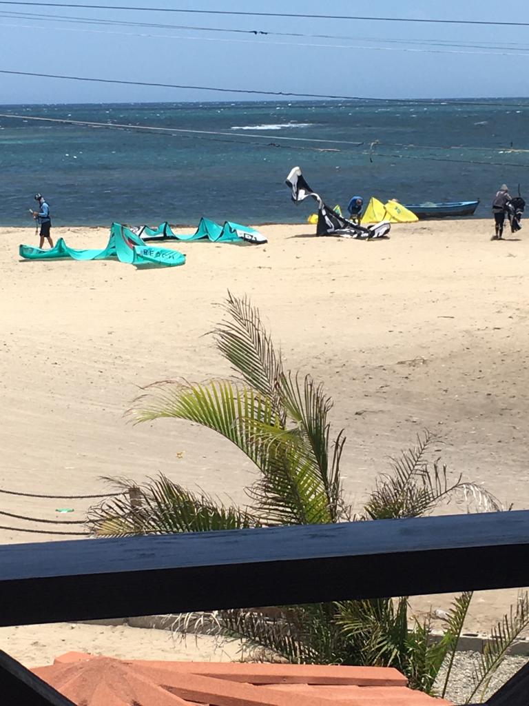 A group of people are flying kites on a beach.