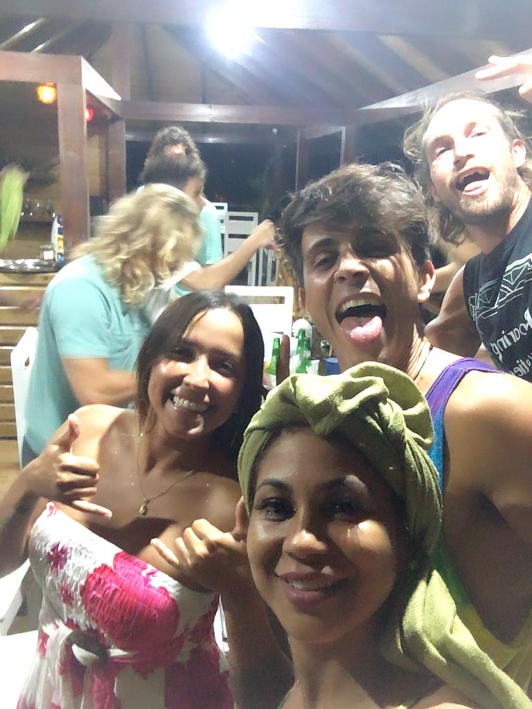 A group of people posing for a picture with one wearing a hurley shirt