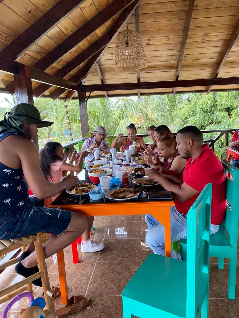 A group of people are sitting at a table eating food.