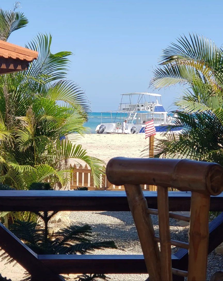 A view of a beach with a boat in the distance
