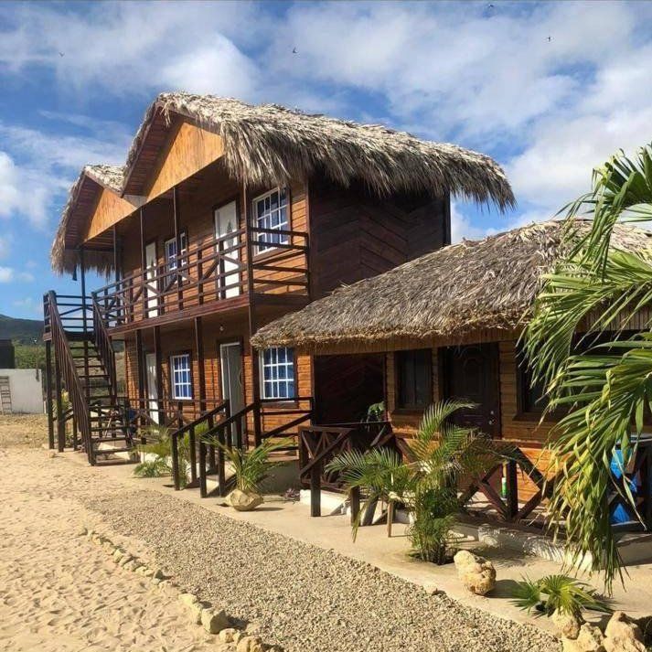 A large wooden building with a thatched roof