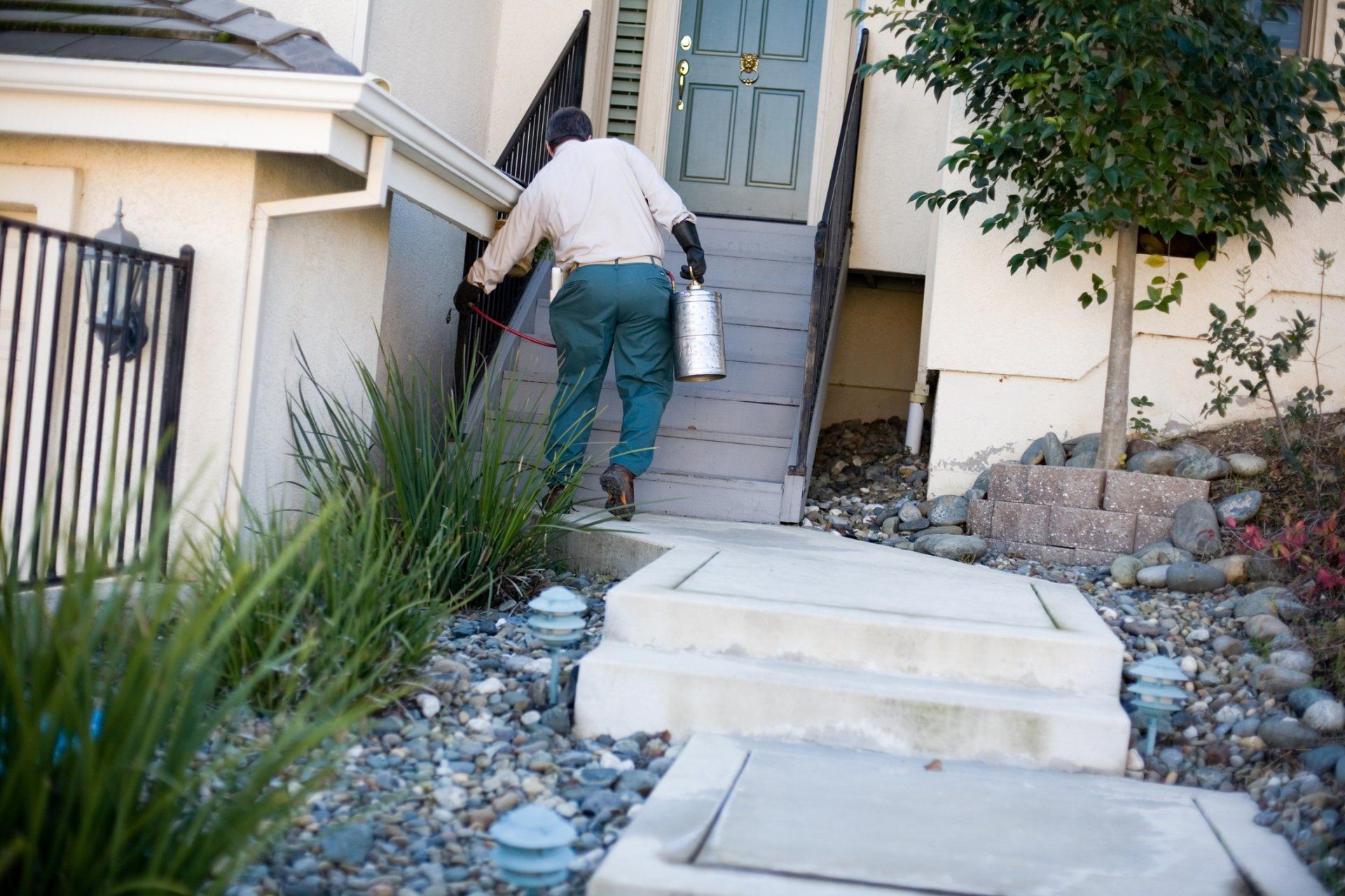 Pest Control Worker Treats Ground Around The House - Warner Robins, GA - Just In Case Pest Control