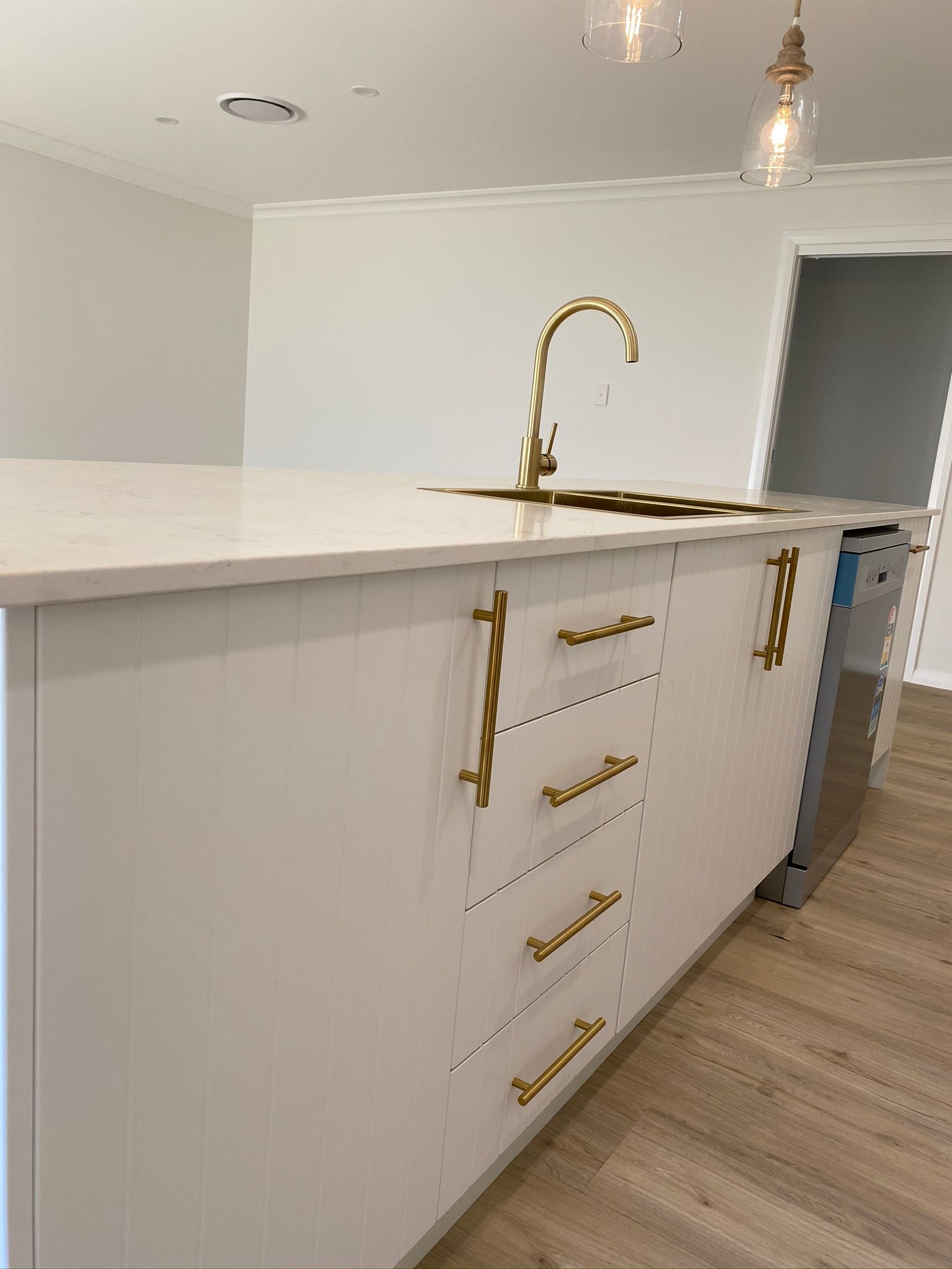 White Cabinets With Gold Sink and Faucet — Kitchen Renovations in Dubbo, QLD