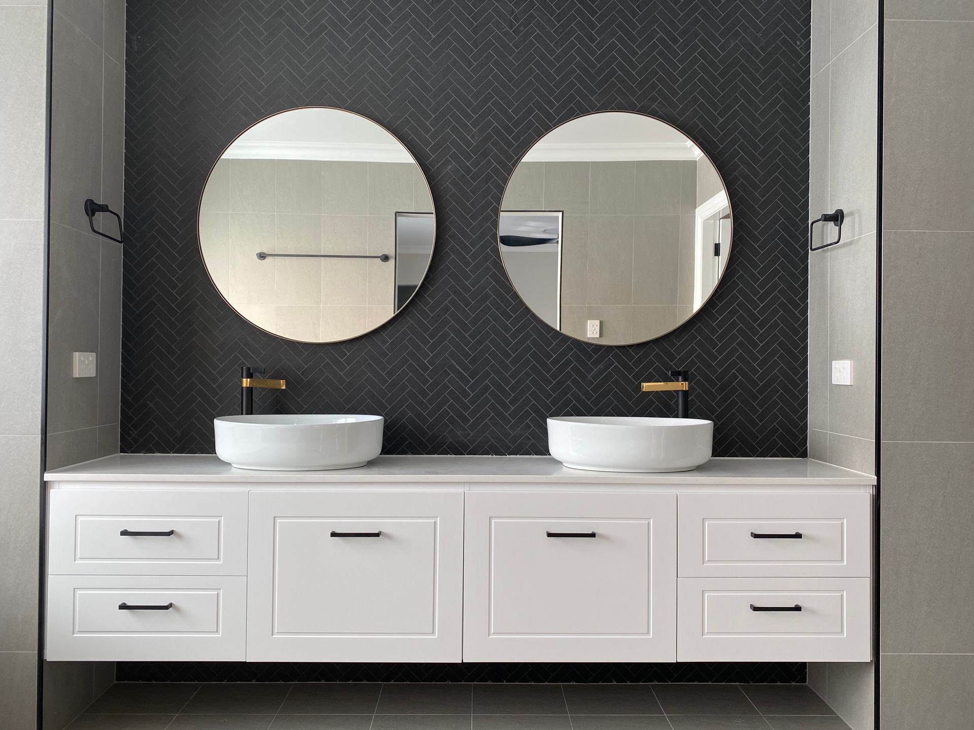 Two White Sink and Mirror With Black Bathroom Tiles — Kitchen Renovations in Dubbo, QLD