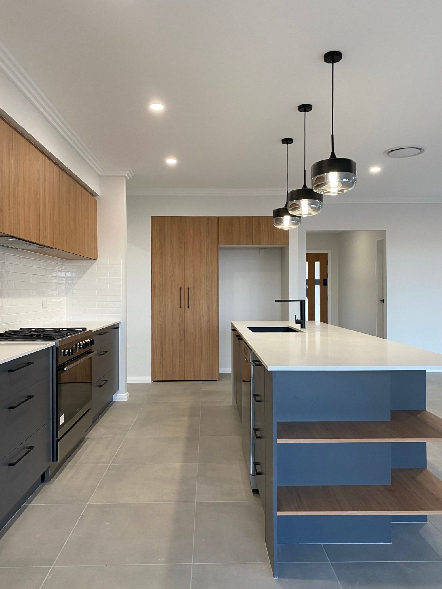 Kitchen Interior With Sink, Cabinets and Gas Oven — Kitchen Renovations in Dubbo, QLD